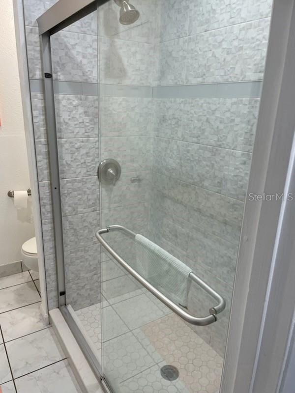 bathroom with toilet and walk in shower