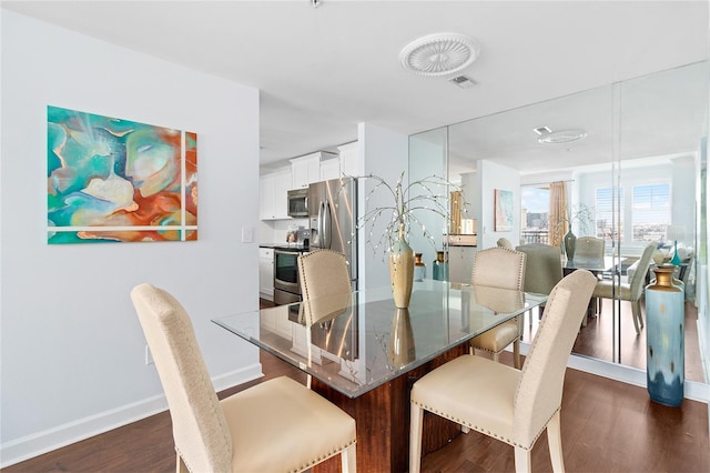 dining area featuring dark hardwood / wood-style flooring