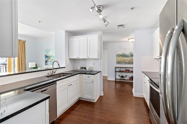 kitchen with sink, stainless steel appliances, tasteful backsplash, dark hardwood / wood-style floors, and white cabinets