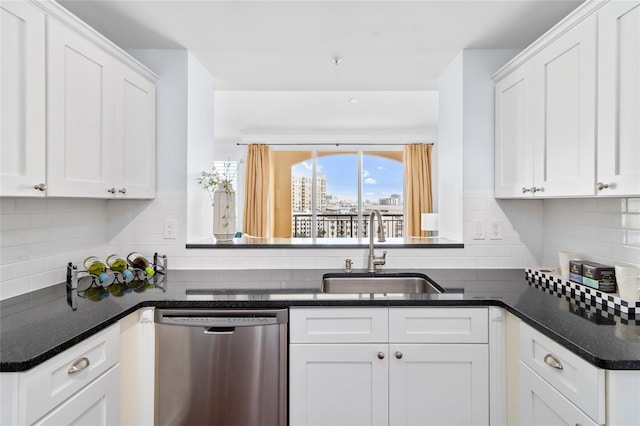 kitchen with decorative backsplash, white cabinetry, stainless steel dishwasher, and sink