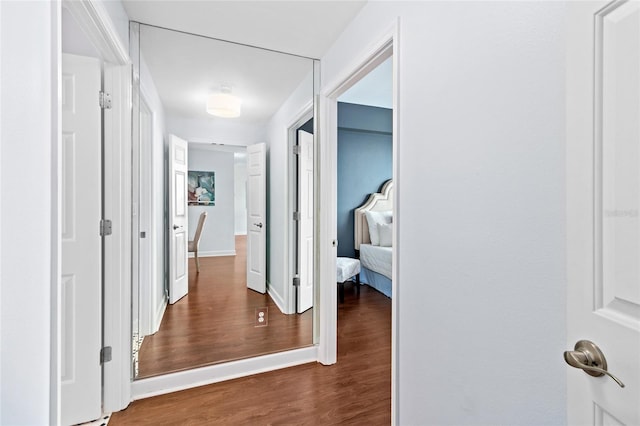 corridor with dark hardwood / wood-style floors