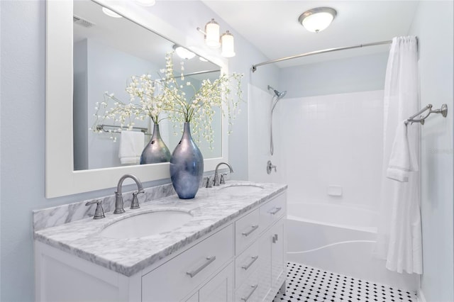 bathroom featuring vanity and shower / bathtub combination with curtain