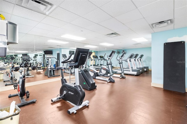 gym with a paneled ceiling