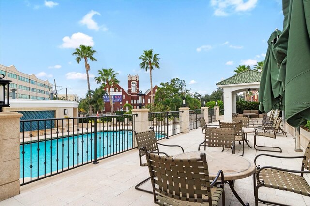 view of patio / terrace featuring a gazebo and a community pool