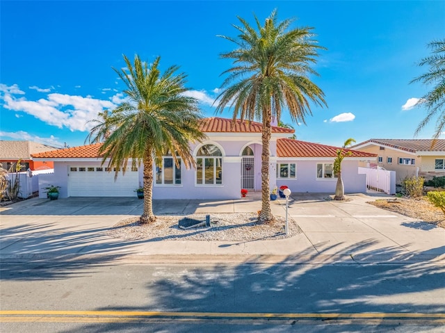 mediterranean / spanish-style home with a garage