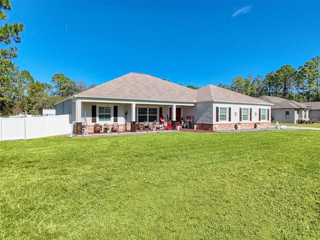 rear view of house with a yard