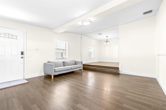 interior space featuring beamed ceiling, dark hardwood / wood-style flooring, and a notable chandelier