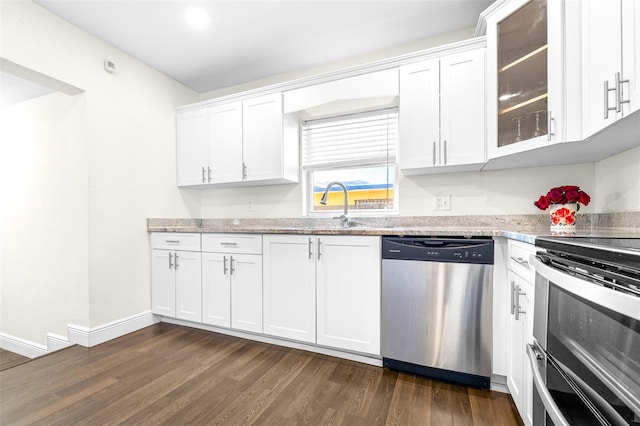 kitchen featuring stainless steel appliances, dark hardwood / wood-style floors, white cabinets, and light stone counters