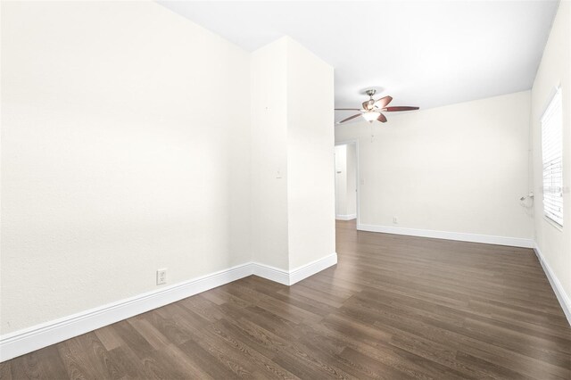 empty room with dark wood-type flooring and ceiling fan