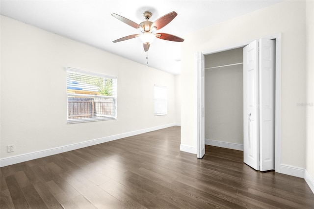 unfurnished bedroom featuring ceiling fan, dark hardwood / wood-style floors, and a closet