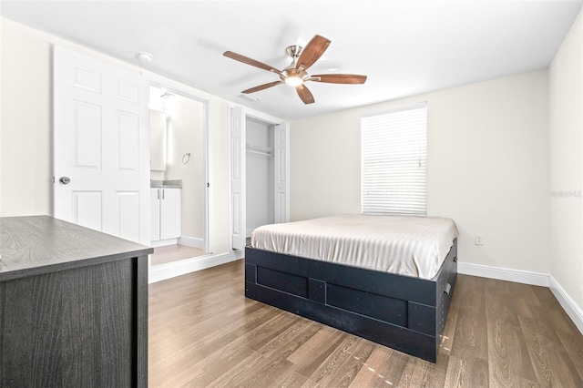 bedroom featuring dark wood-type flooring, ceiling fan, and a closet