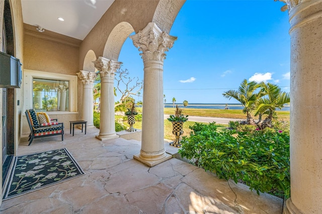 view of patio / terrace featuring a porch and a water view