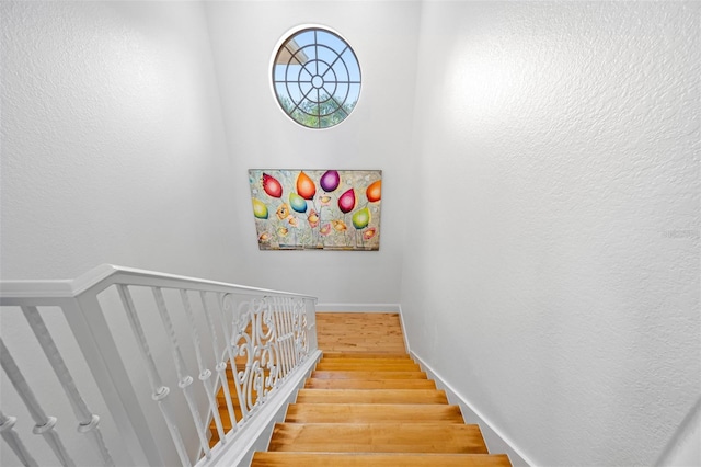 stairs featuring hardwood / wood-style floors