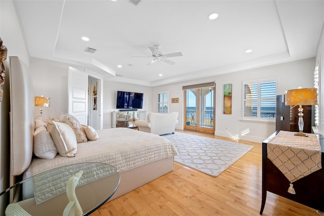 bedroom with ceiling fan, access to exterior, light wood-type flooring, and multiple windows