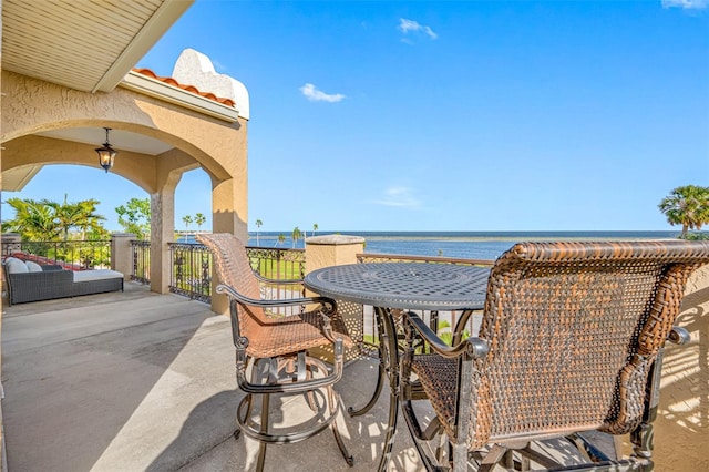 view of patio with a water view