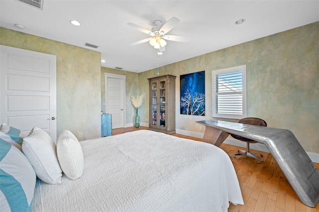 bedroom featuring hardwood / wood-style flooring and ceiling fan