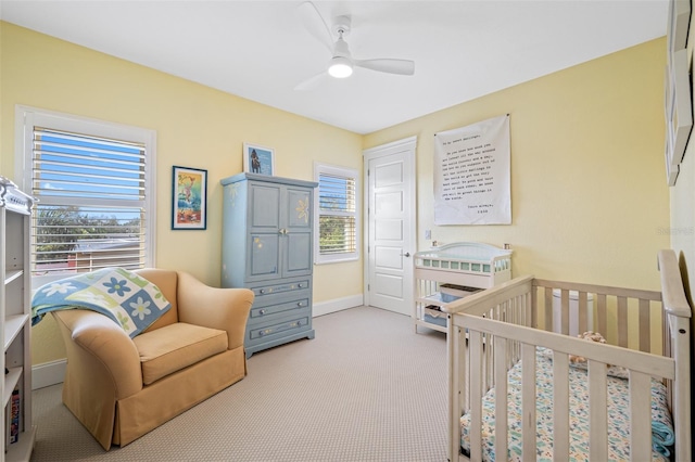 bedroom featuring light carpet and ceiling fan