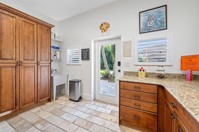 kitchen with light stone countertops and sink