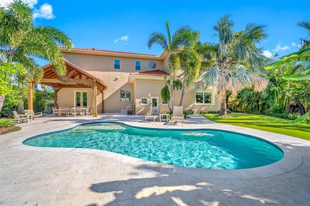 view of swimming pool featuring a yard and a patio