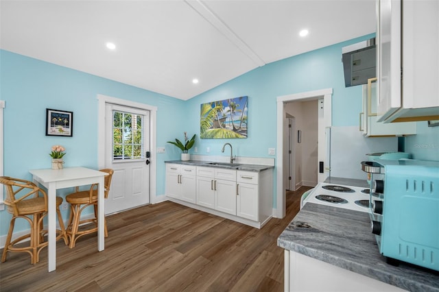 kitchen featuring dark wood-type flooring, sink, white electric stove, white cabinets, and lofted ceiling