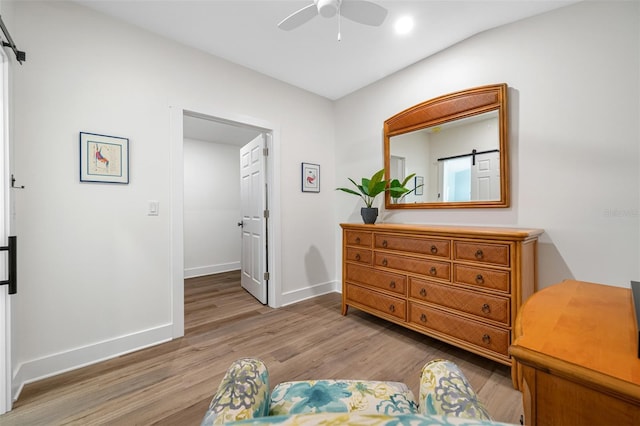 sitting room with hardwood / wood-style floors and ceiling fan