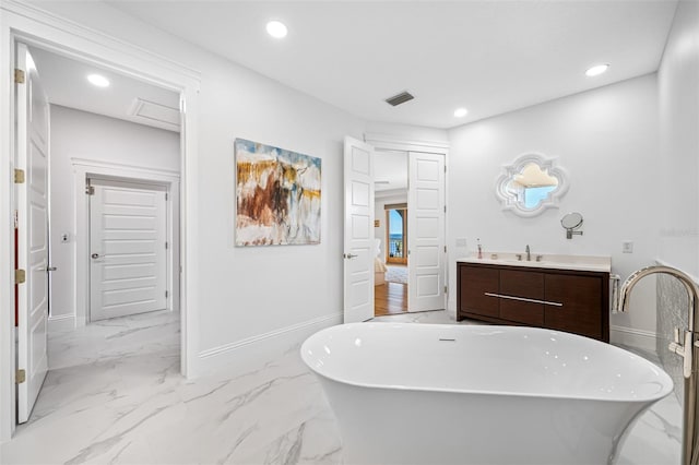 bathroom featuring vanity and a washtub