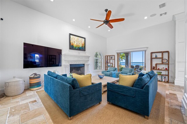 living room featuring ceiling fan and a high ceiling