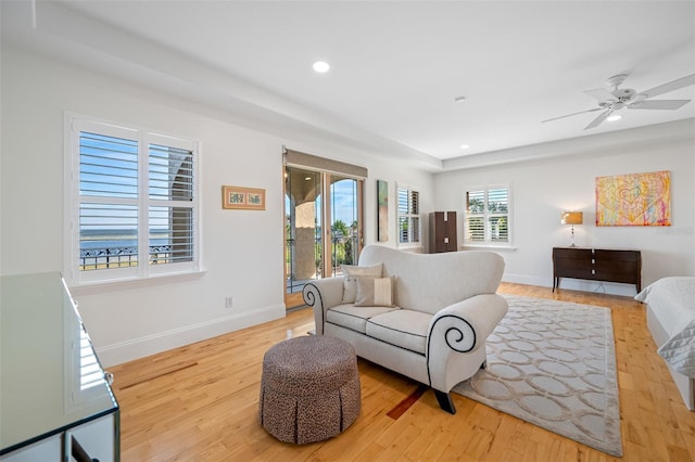 living room featuring ceiling fan and light hardwood / wood-style floors