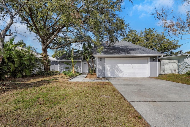 single story home with a garage and a front lawn