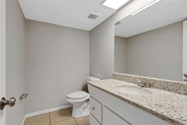 bathroom with vanity, tile patterned floors, and toilet