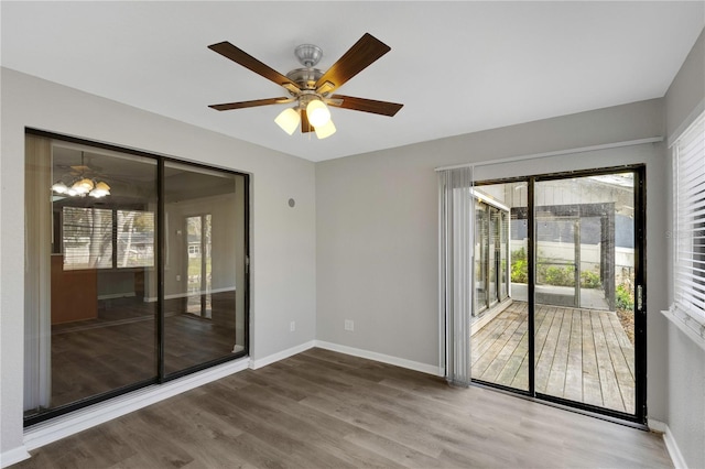 spare room featuring wood-type flooring and ceiling fan