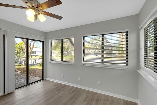 unfurnished room featuring plenty of natural light, light hardwood / wood-style floors, and ceiling fan