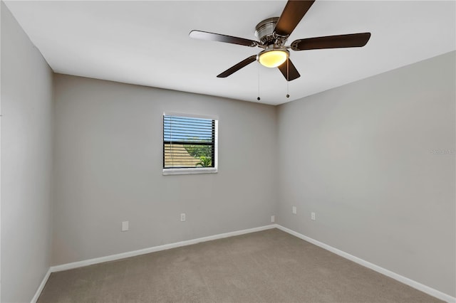 empty room with ceiling fan and light carpet