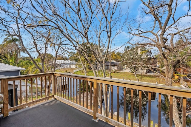 wooden terrace featuring a water view