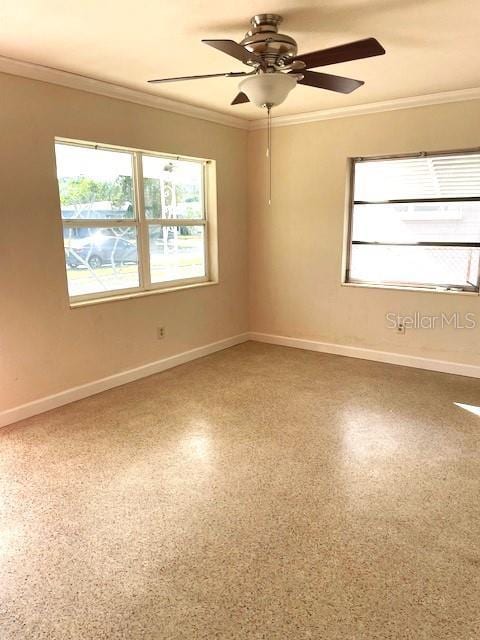 empty room with ceiling fan, a healthy amount of sunlight, and ornamental molding