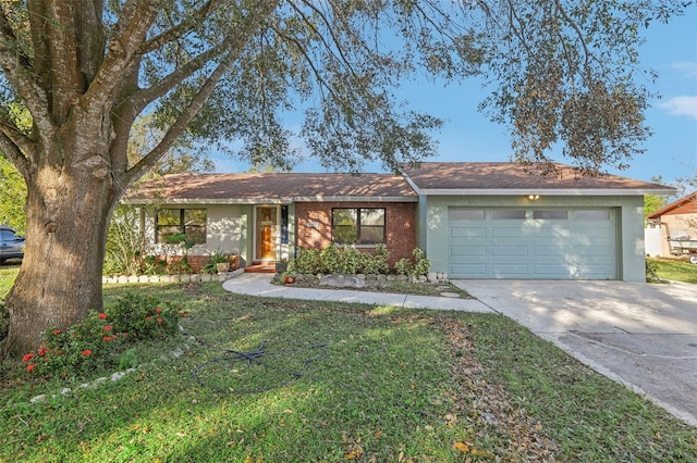 single story home featuring a front lawn and a garage