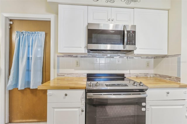 kitchen with decorative backsplash, white cabinetry, and appliances with stainless steel finishes