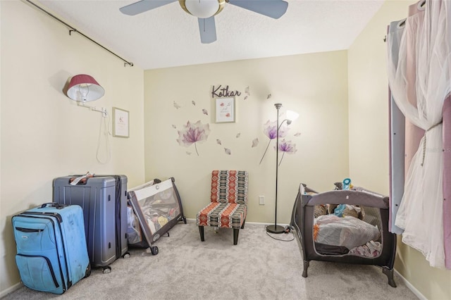 interior space with ceiling fan and light colored carpet