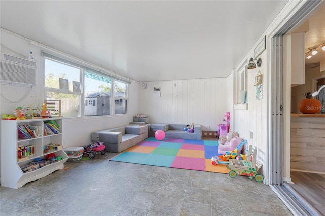 rec room featuring wooden walls and a wall mounted AC