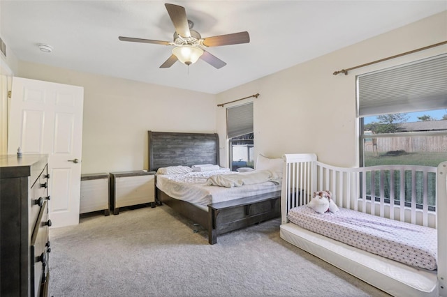 bedroom with light colored carpet and ceiling fan