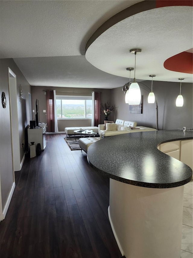 interior space with dark hardwood / wood-style flooring and a textured ceiling