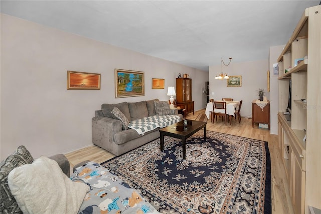 living room featuring light hardwood / wood-style floors and an inviting chandelier