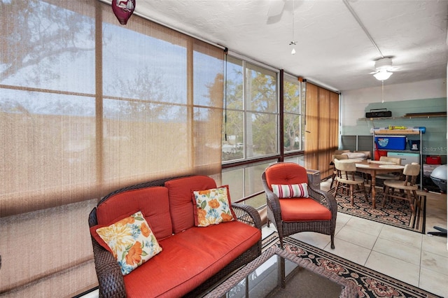 sunroom featuring ceiling fan