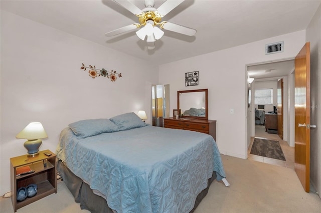 bedroom featuring light colored carpet and ceiling fan