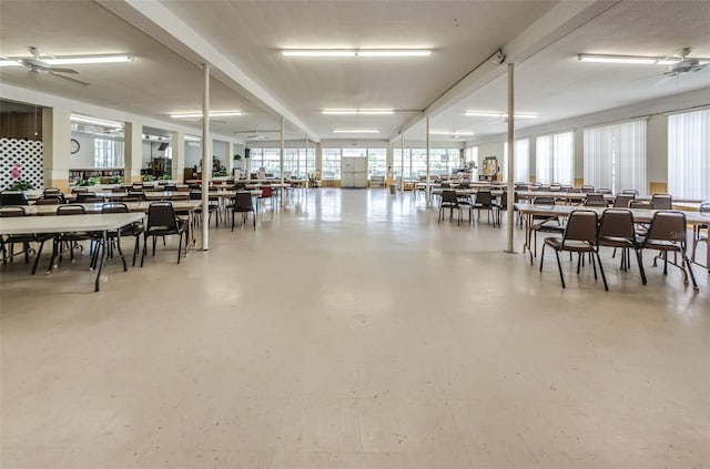 dining area with ceiling fan and concrete flooring