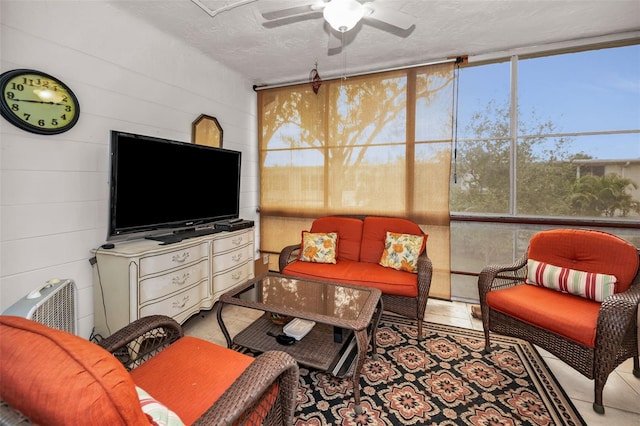 sunroom featuring a ceiling fan