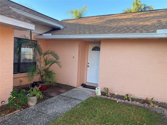 5105 Garden Vale Ave, Tampa, FL 33624 - property entrance with a shingled roof and stucco siding