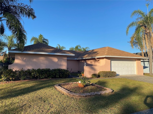 5105 Garden Vale Ave, Tampa, FL 33624 - single story home with stucco siding, driveway, an attached garage, and a front yard