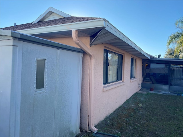 5105 Garden Vale Ave, Tampa, FL 33624 - view of home's exterior featuring stucco siding, roof with shingles, and a yard