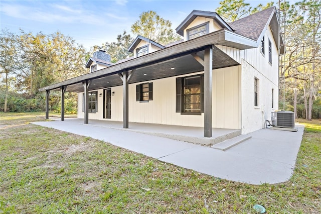 rear view of house with a lawn, a patio area, and central AC